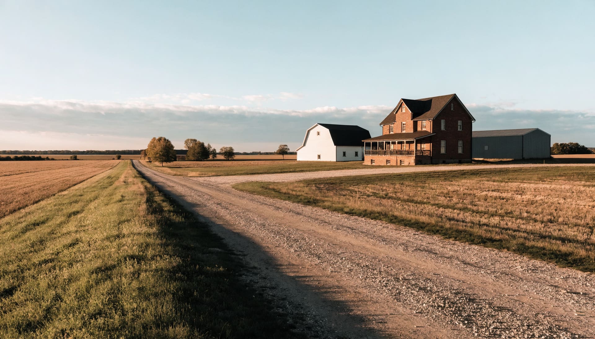 A brick farmhouse and outbuildings on farmland (representative image)